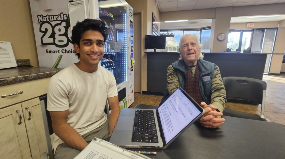 University of Arizona student of physiology and medical sciences Karthik S. Srinivas pauses to smile for a picture after practicing some memory and language-enriching activities with 92-year old George Wolfson.   
